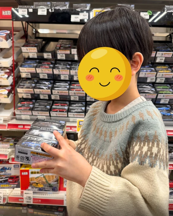 His son choosing Tomica cars